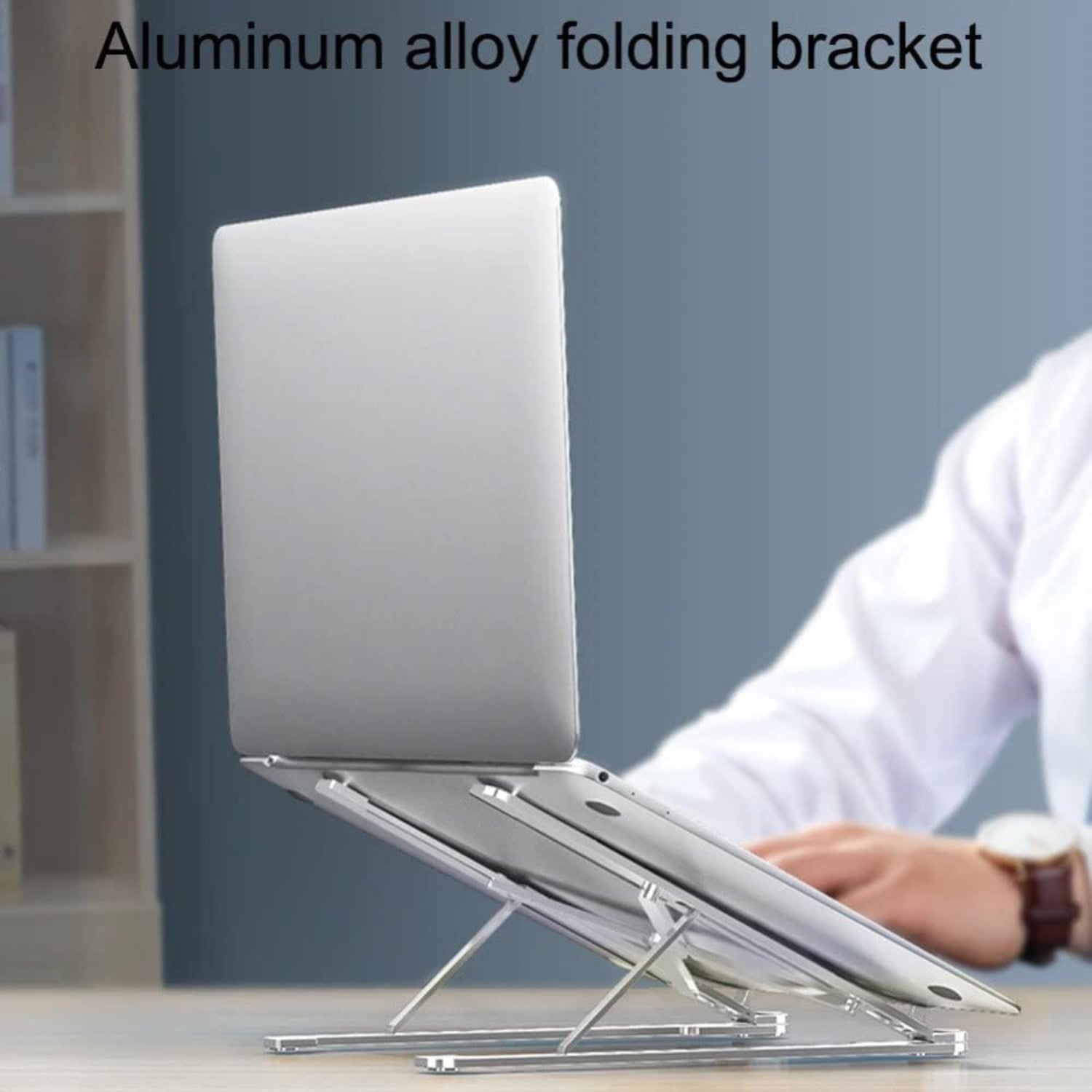 Aluminum alloy folding bracket holding a laptop on a desk with a blurred background.