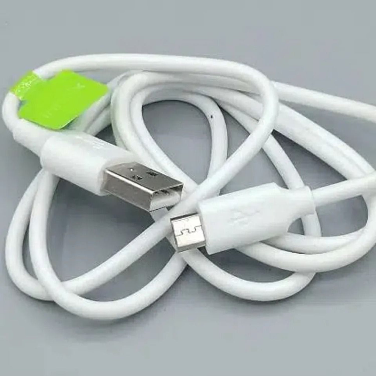 White USB cable with a green tag on a gray background