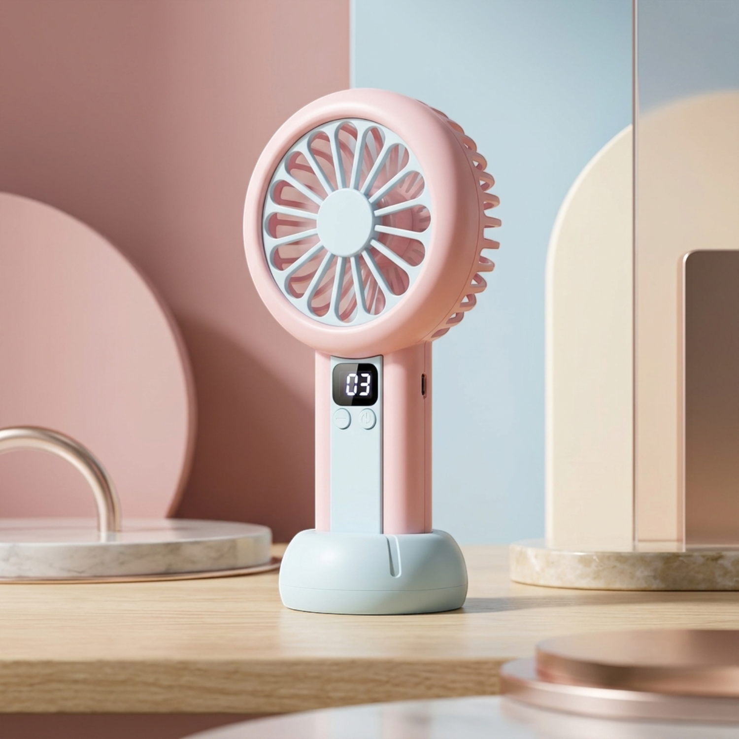 Pink handheld fan with digital display on a wooden surface.