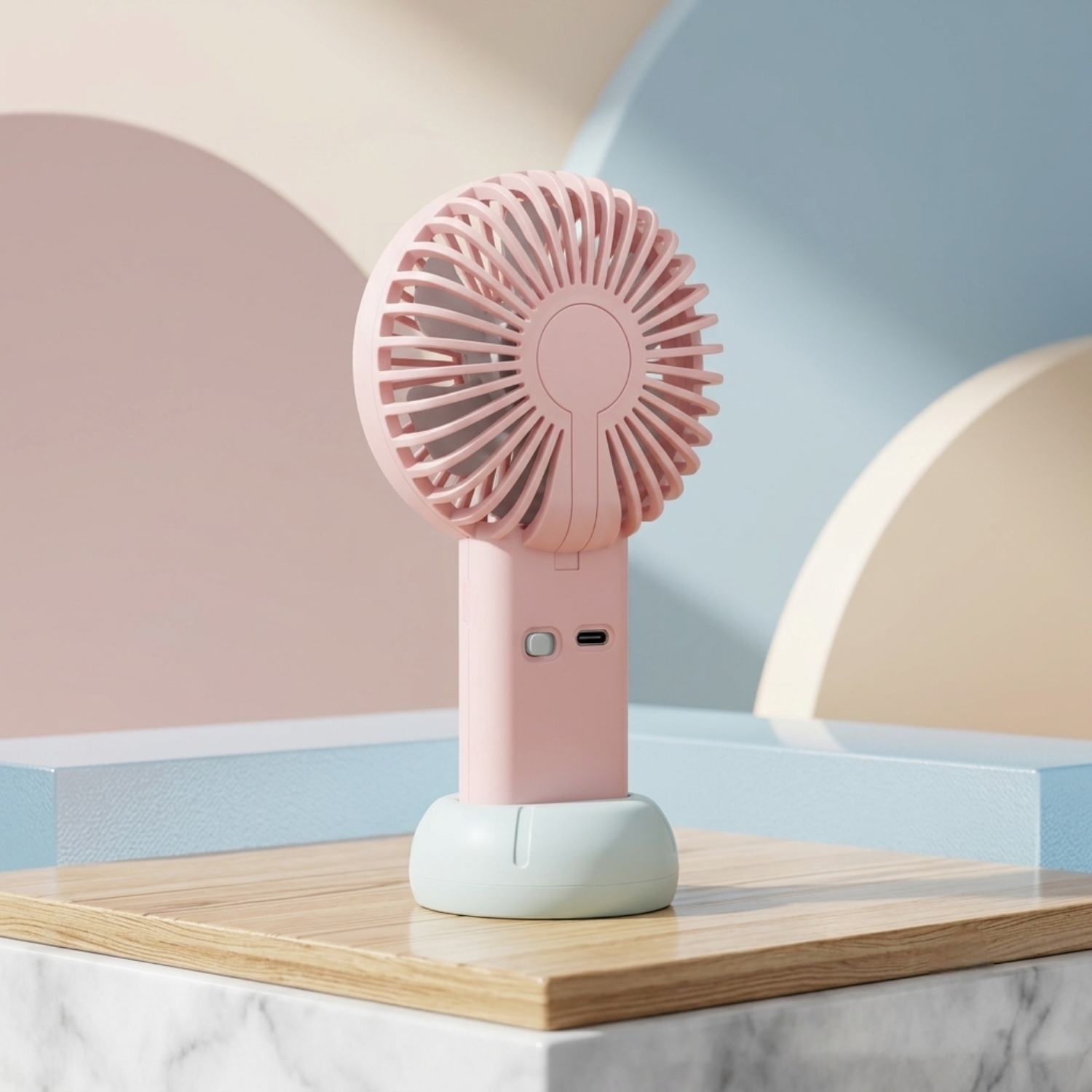 Pink handheld fan on a wooden surface with a pastel-colored background.