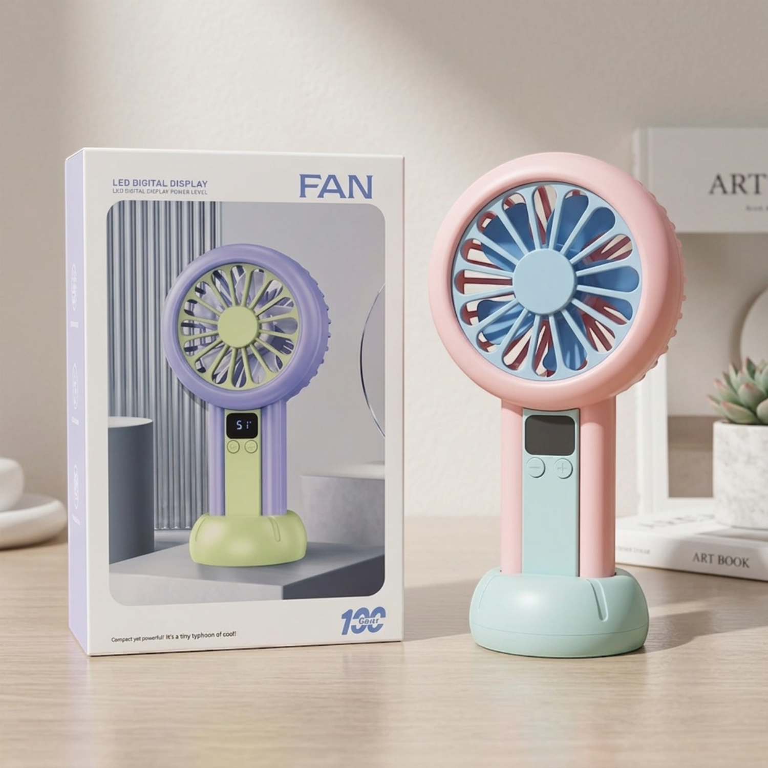 Colorful handheld fan with packaging on a wooden surface.