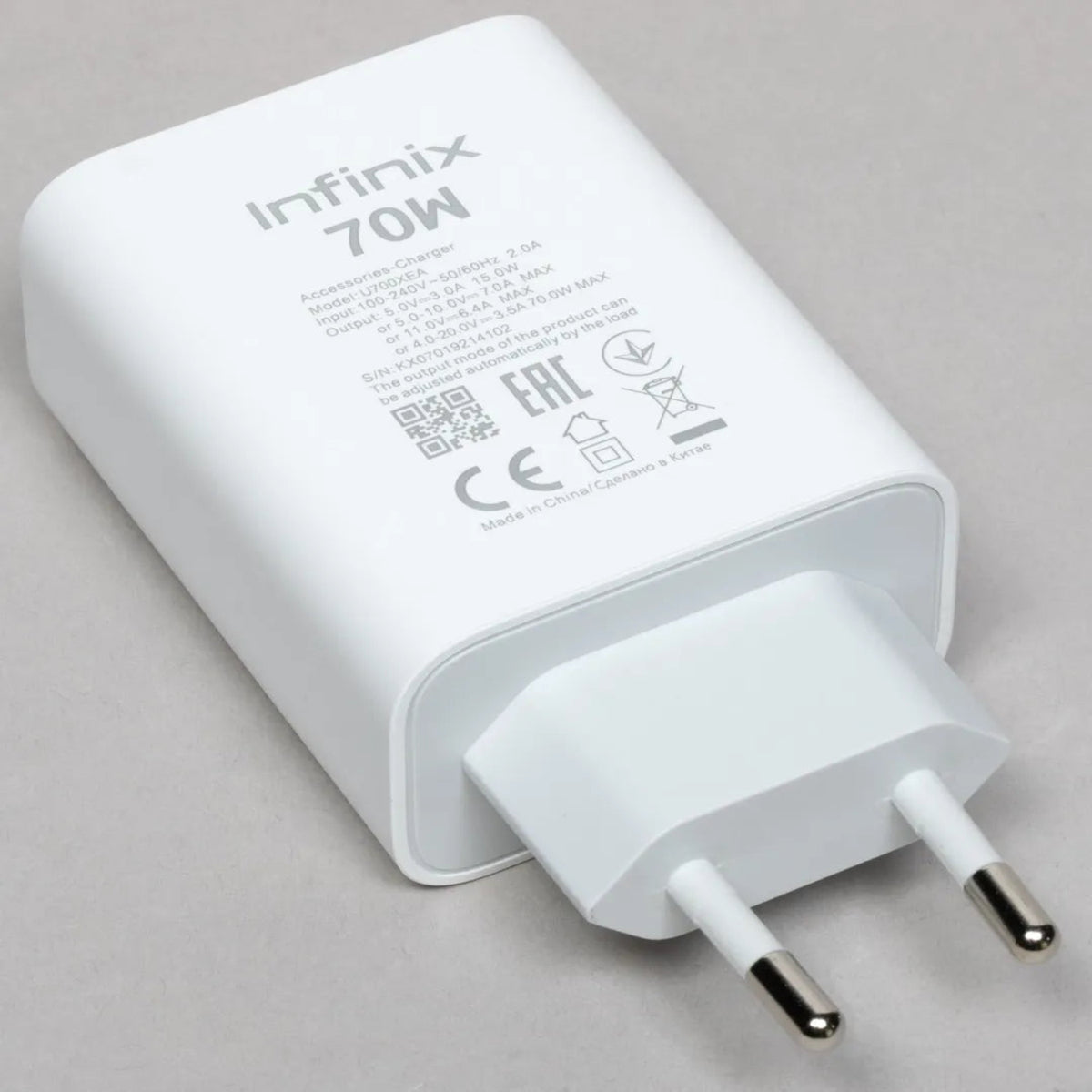 Infinix 70W charger on a gray background