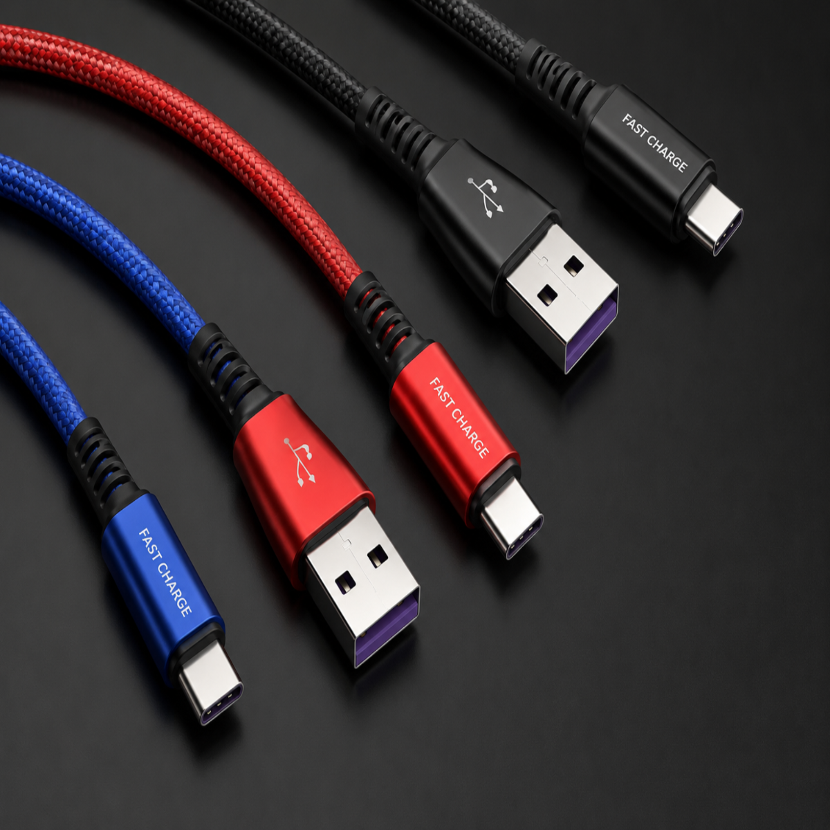 Three braided USB-C charging cables in blue, red, and black, arranged diagonally on a dark background. Each cable has a USB-A connector on one end and a USB-C connector on the other, with 'FAST CHARGE' printed on the metal connector housing.