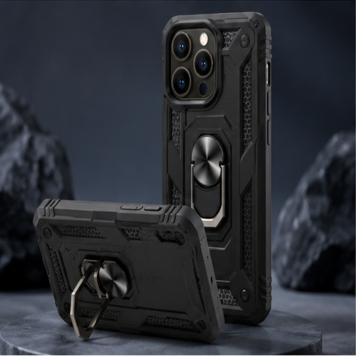 A rugged black protective phone case with an integrated metal ring kickstand, shown from both front and back angles on a dark studio set.
